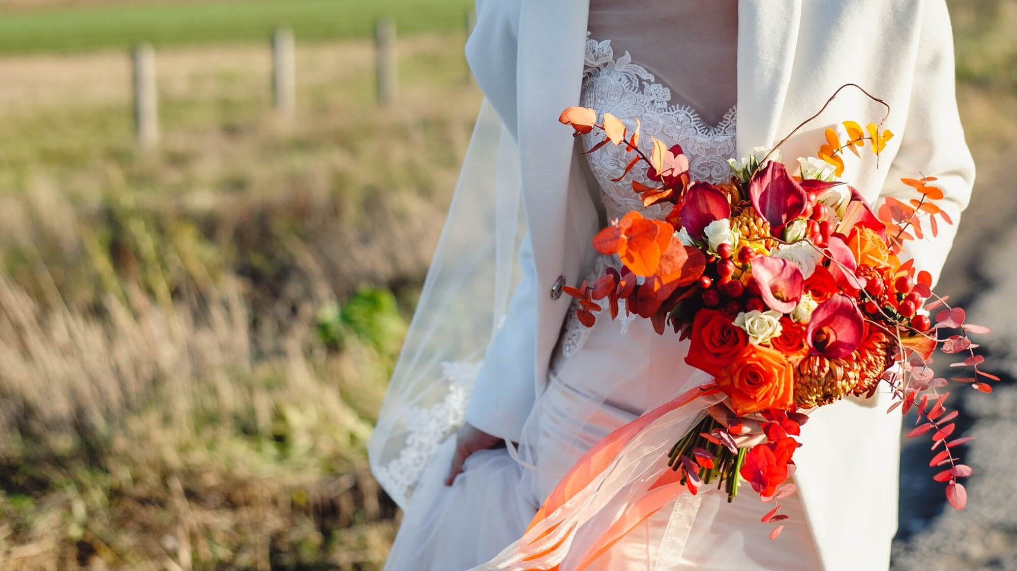 bride holding fall floral wedding bouquet