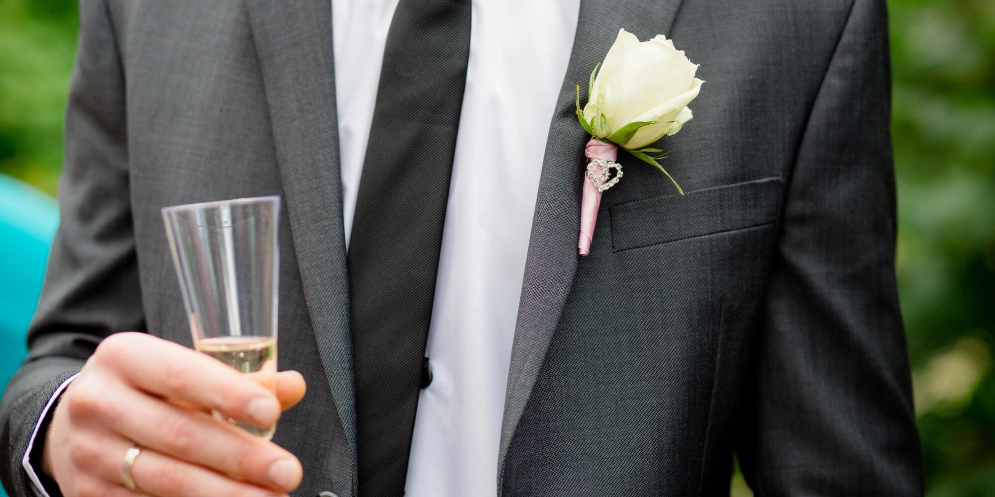 father of the groom holding a glass full of champagne ready to give a toast to the bride and groom