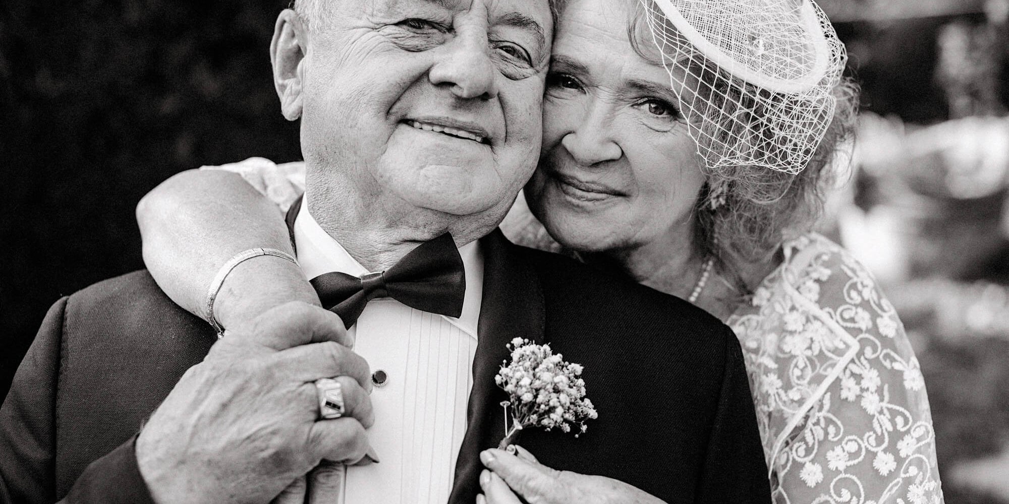 grandfather and grandmother hugging at wedding ceremony