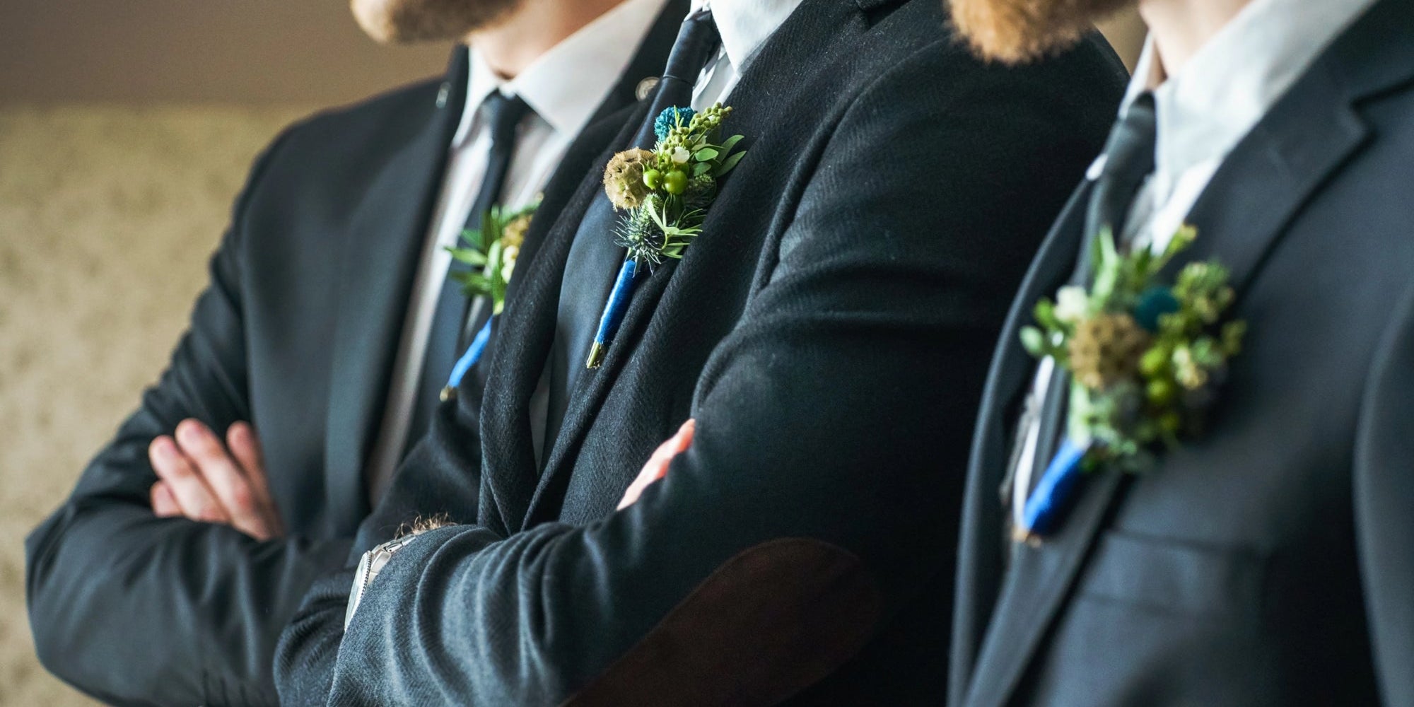 groomsmen standing in line together at wedding