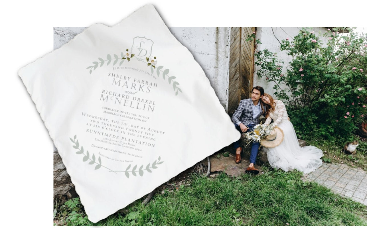 wedding couple sitting on steps behind invitation handkerchief overlay