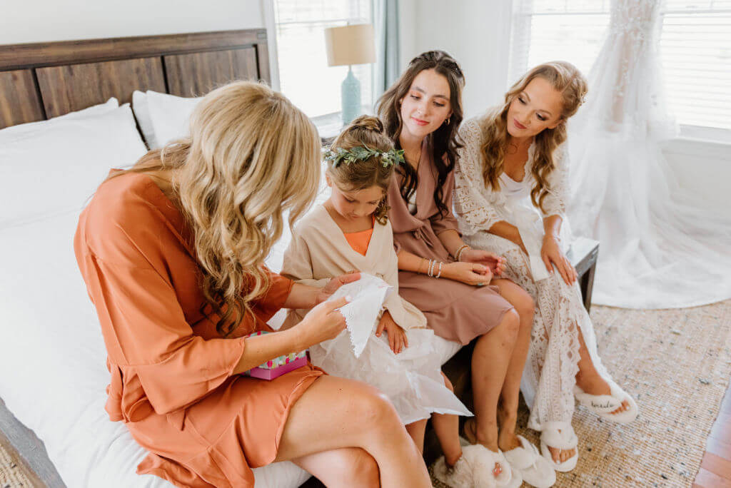 flower girl accepting handkerchief gift from bride