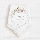 wedding keepsake handkerchief that is personalized with the bride and groom names and wedding date.  The text is surrounded by a graphic of pink florals