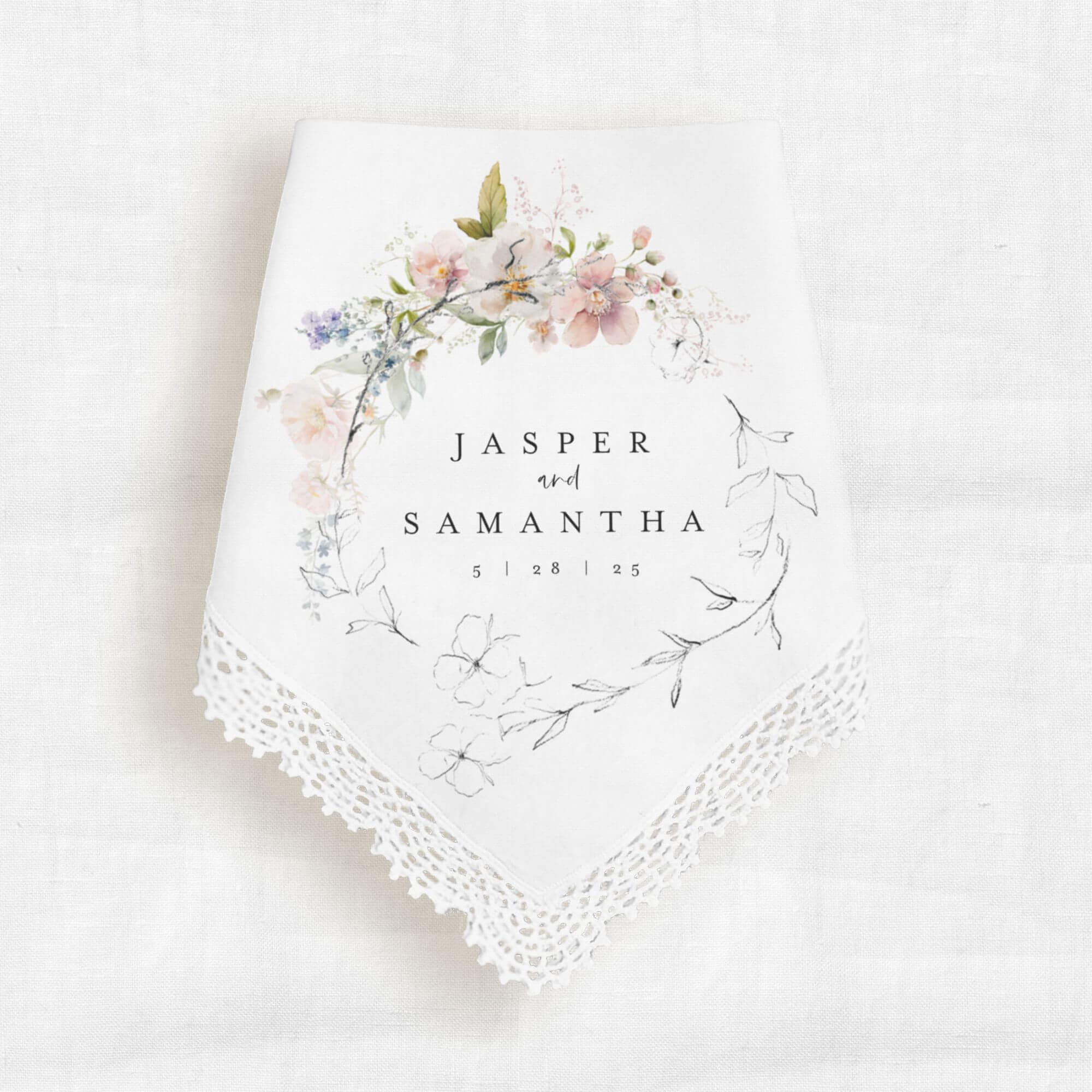 wedding keepsake handkerchief that is personalized with the bride and groom names and wedding date.  The text is surrounded by a graphic of pink florals
