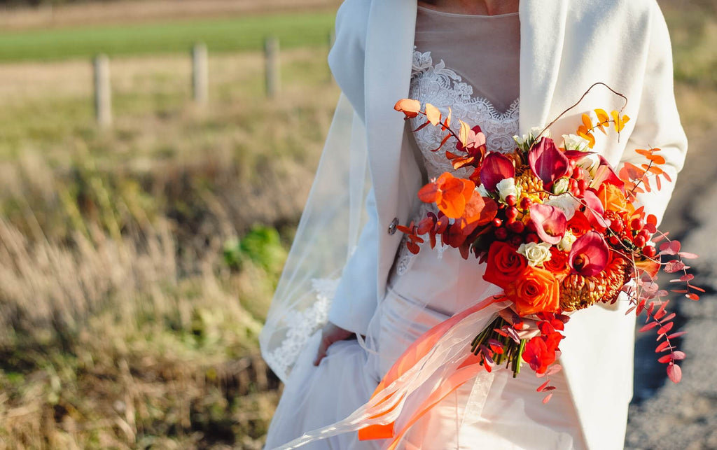 bride holding fall floral wedding bouquet