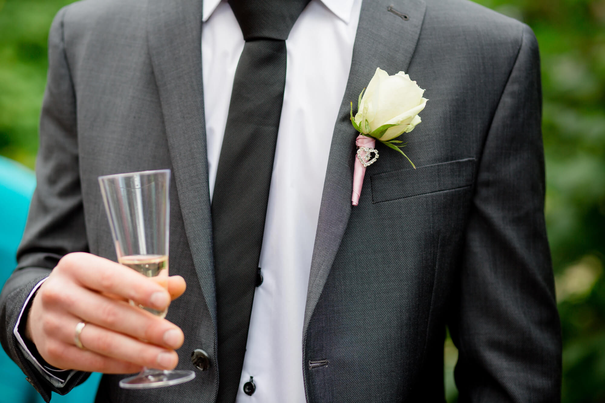 father of the groom holding a glass full of champagne ready to give a toast to the bride and groom