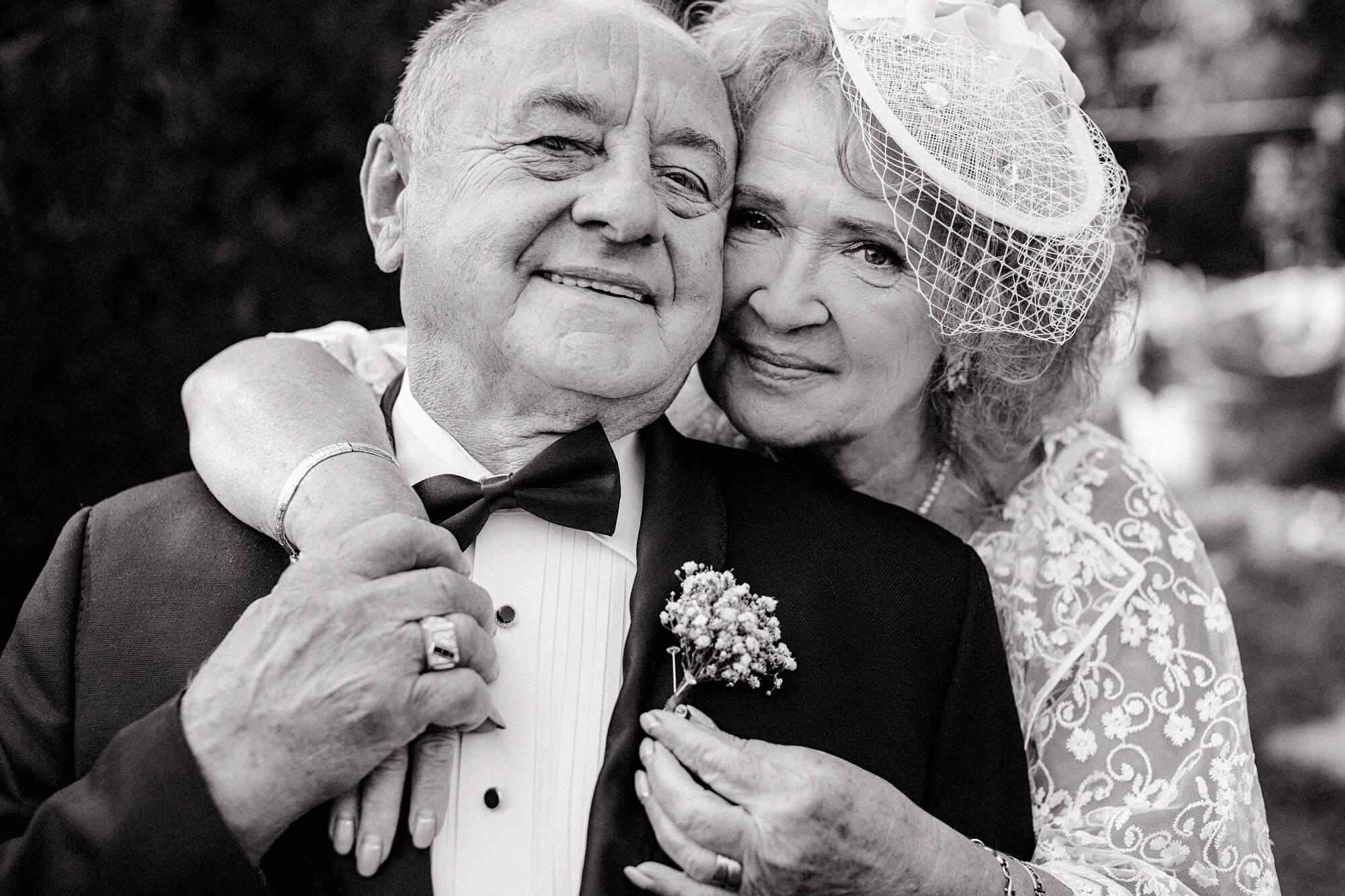 grandfather and grandmother hugging at wedding ceremony