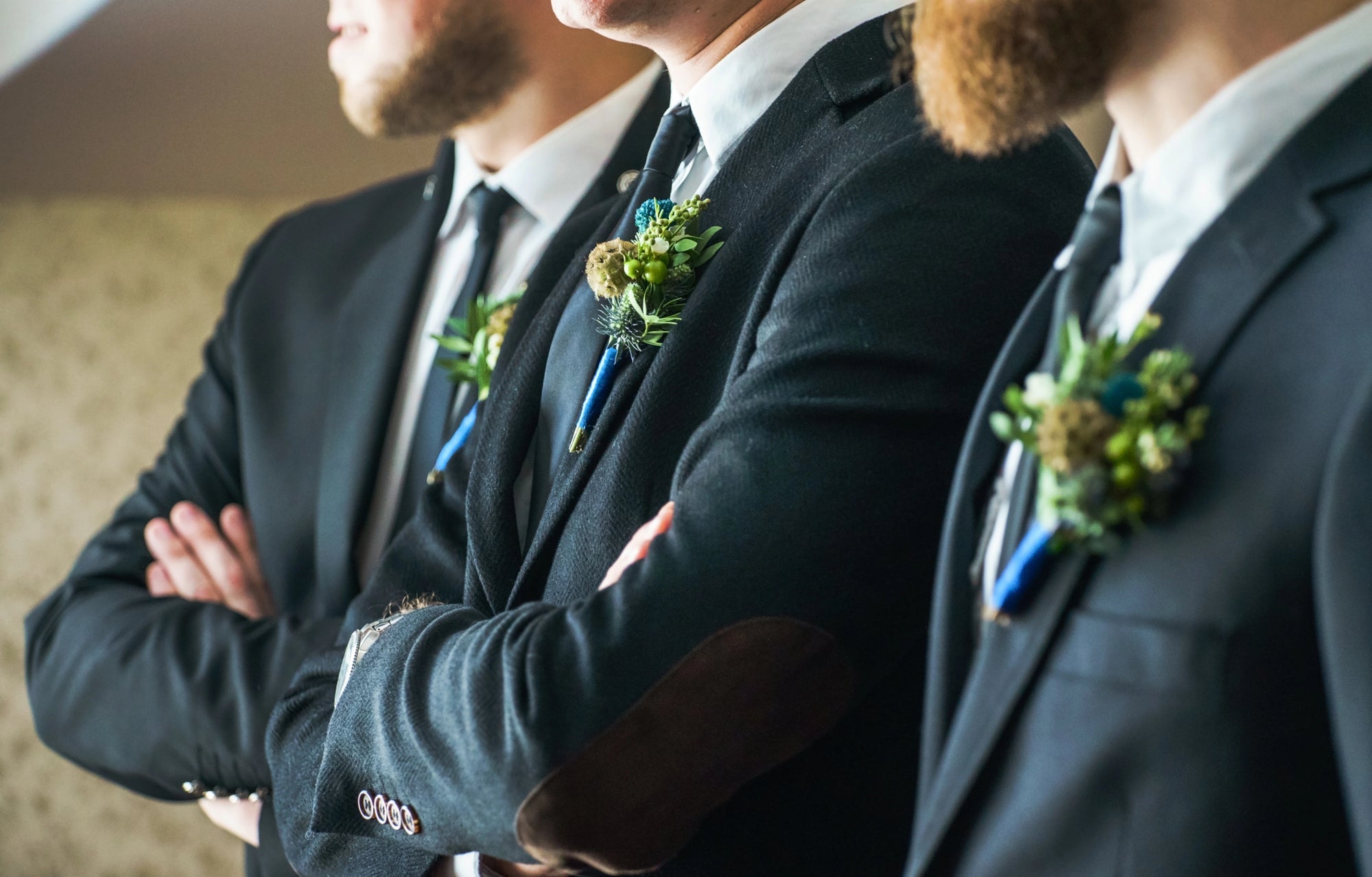 groomsmen standing in line together at wedding