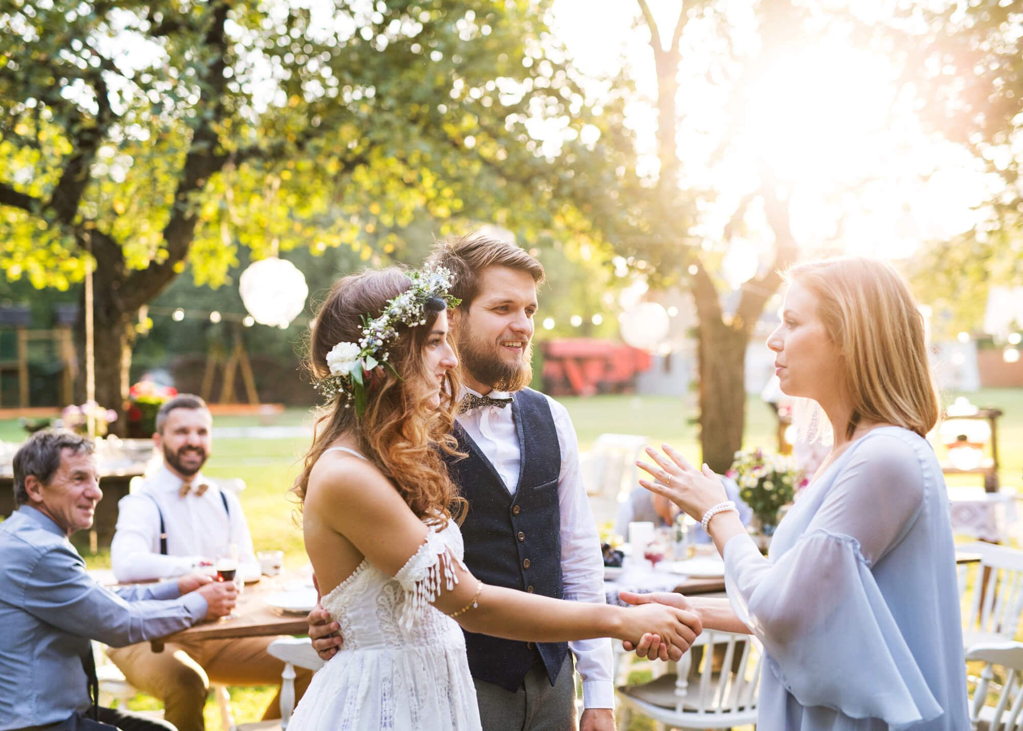 bride and groom talking to the mother of the groom