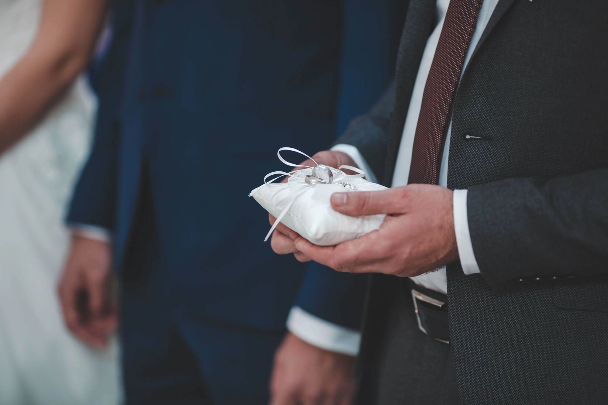 ring bearer holding pillow with wedding rings