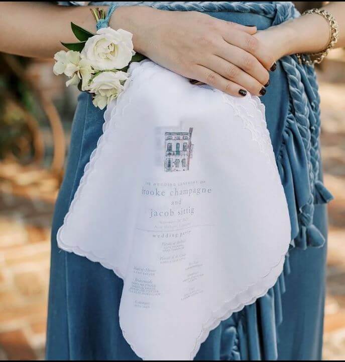 bride holding wedding program handkerchief