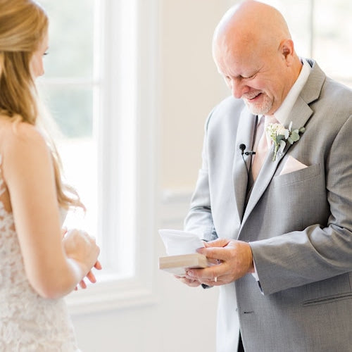 father of the bride receiving gift handkerchief from bride