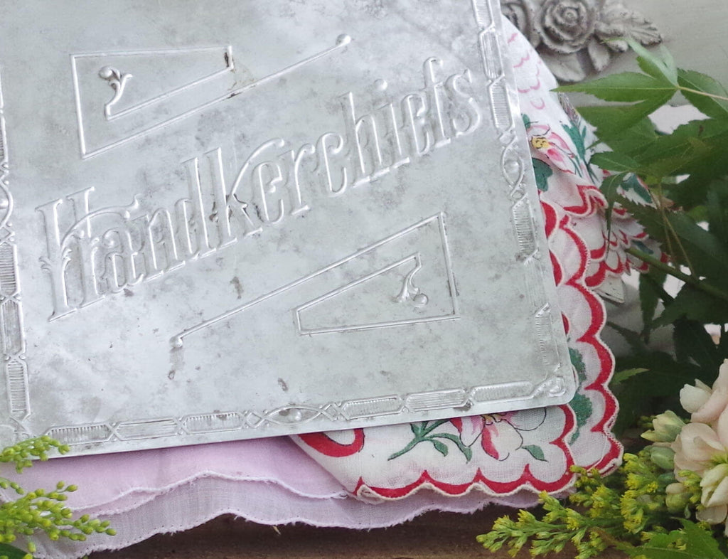 antique metal handkerchief sign with white flowers