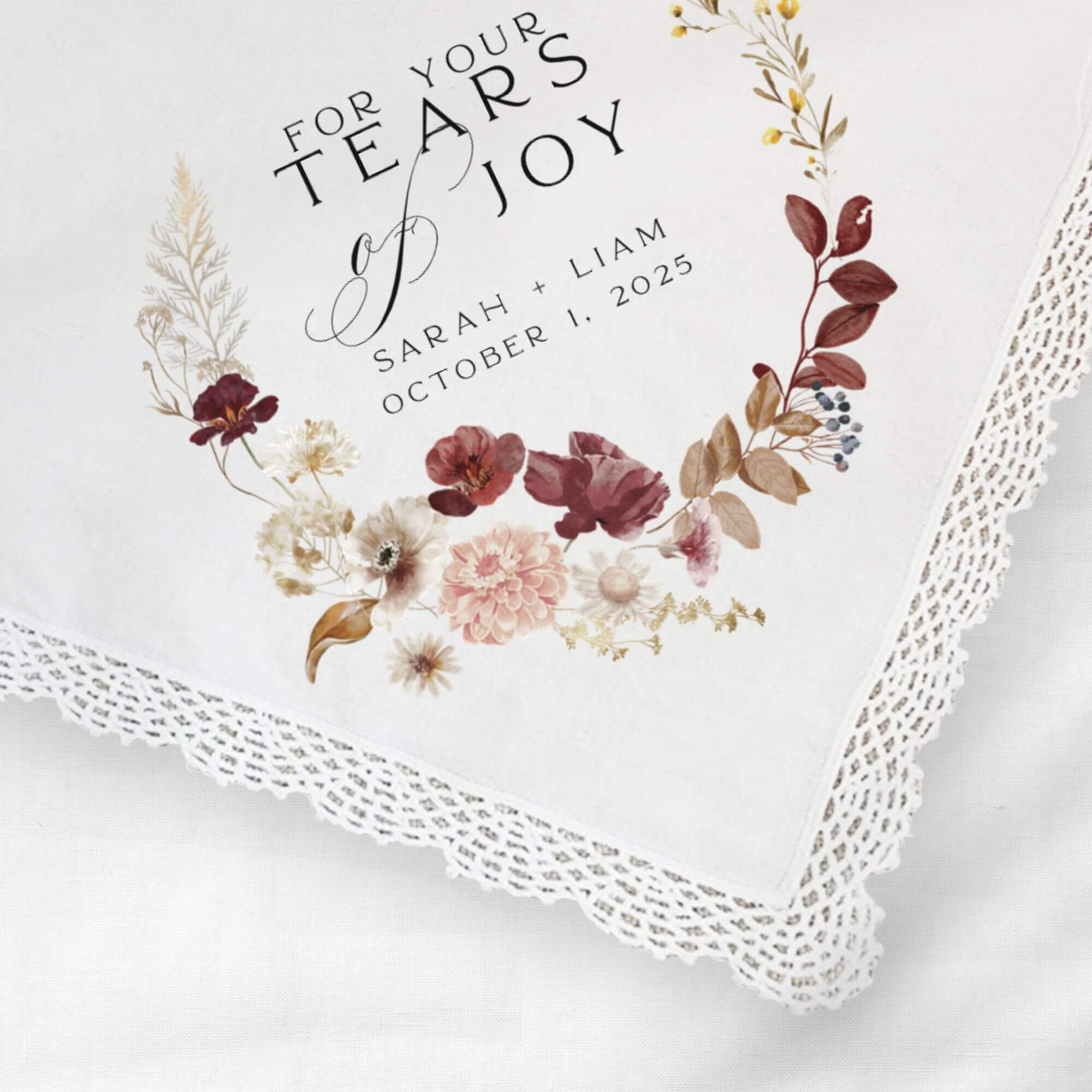 for your tears of joy wedding favor handkerchief with lace trim and personalized with the bride and groom's names and wedding date.  Pink and dark red floral graphic  surrounds the text